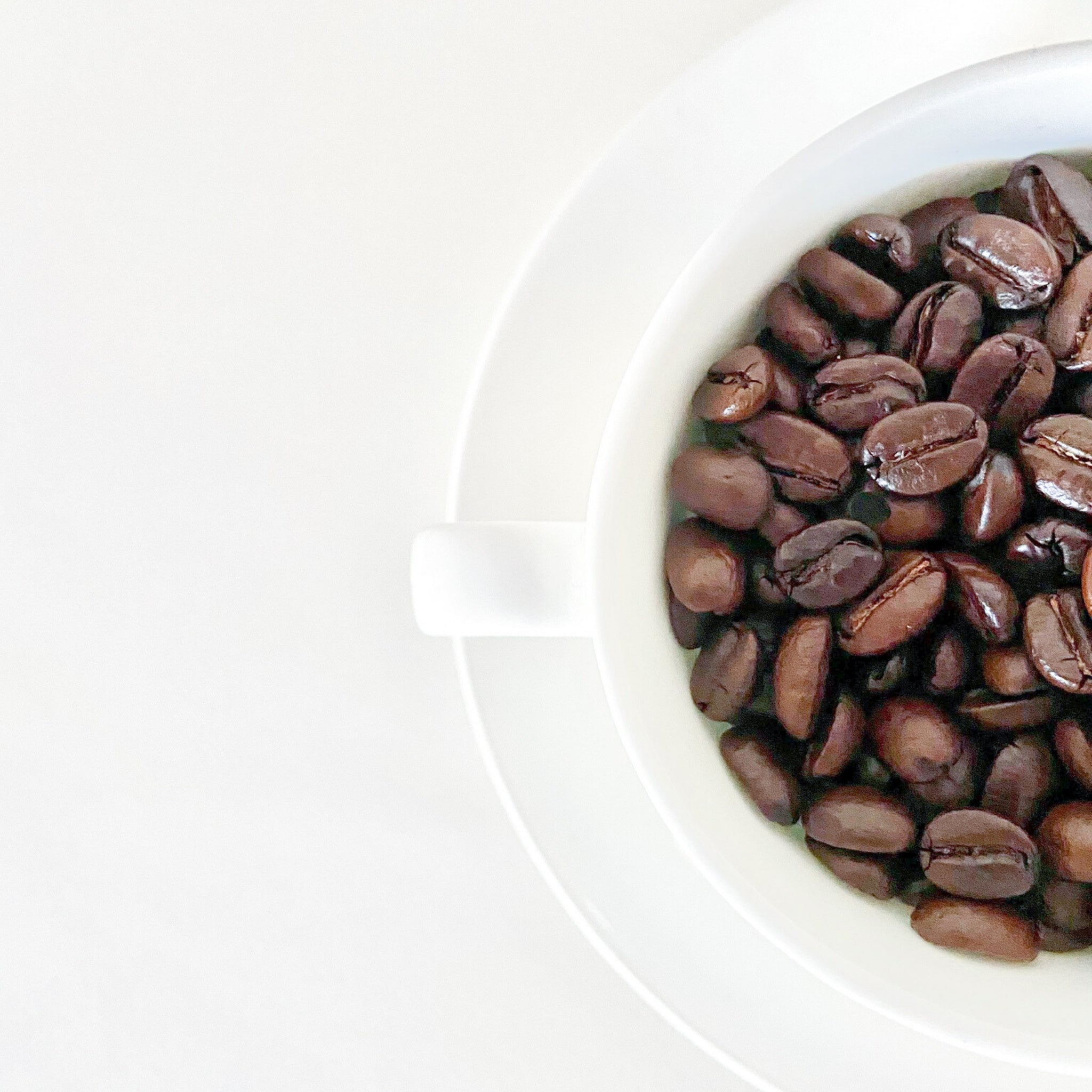 Coffee Beans In A Cup On White Background