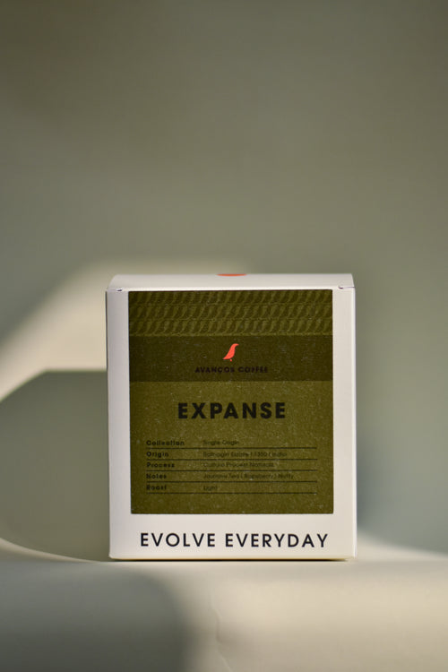 Product packaging with 'Expanse' and 'Evolve Everyday' text on a neutral background